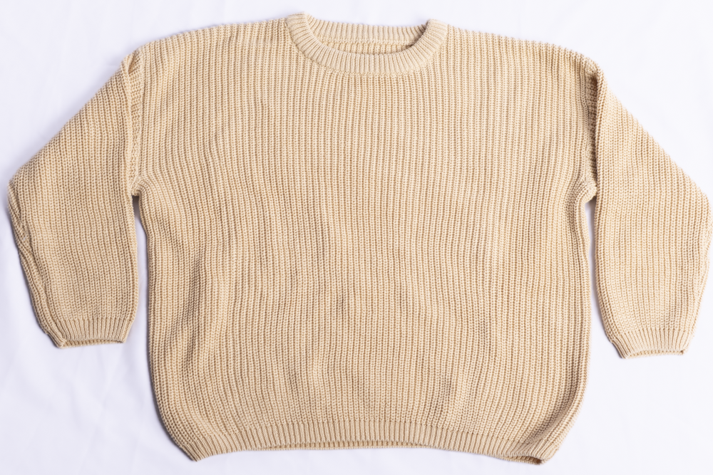 A beige ribbed knit crewneck sweater laid flat on a white background.