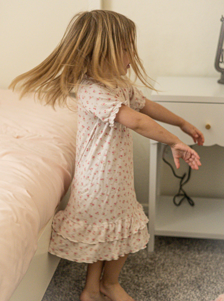 Girl twirling in Little Rosebuds bamboo nightgown
